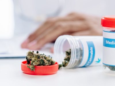 selective focus of bottle with medical cannabis on white table